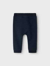 Pantalons de jogging en coton bleu marine avec une texture douce, taille élastique et chevilles resserrées. Design simple, adapté à une tenue décontractée.