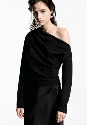 Black off-shoulder top made from textured fabric, adorned with small shimmering accents, featuring long sleeves and a draped design.