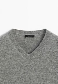 Szary wełniany sweter w serek z prążkowanym dekoltem i metką z napisem "Massimo Dutti." Tekstura wydaje się miękka i lekko melanżowa.