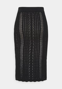 Gonna midi nera lavorata a maglia con una fascia in vita strutturata, caratterizzata da un motivo traforato e linee verticali. Il dettaglio dell'orlo smerlato aggiunge texture.
