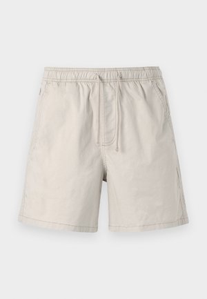 Pantaloni corti beige realizzati in tessuto leggero, dotati di una vita elastica, lacci e tasche laterali con cuciture in contrasto.