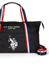 Sac à main en nylon noir avec logo blanc, accents rayés rouge, blanc et bleu. Dispose de deux poignées et d'une bandoulière réglable.