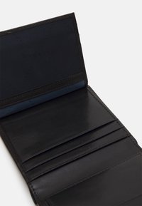 Black leather wallet with a smooth finish, featuring multiple card slots and a blue lined interior, displayed open to show inside structure.