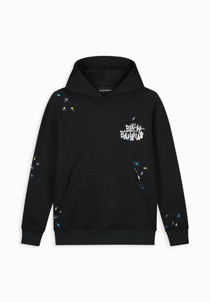 Hoodie noir en coton avec une poche avant. Présente des motifs de taches colorées et le logo "BLACK BANANA" en blanc sur la poitrine.