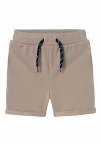 Pantalones cortos beige de tela texturizada, con cinturilla elástica y un cordón azul marino con puntos blancos. Presenta dobladillos enrollados y bolsillos laterales.