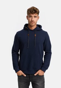 Navy blue hoodie with a front pocket, adjustable drawstrings, and leather accents. Textured fabric with a classic fit.