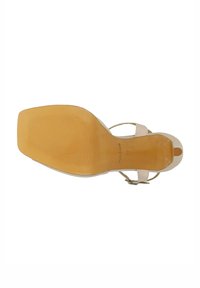 Sandal con tacco alto beige con design a punta aperta, suola in gomma color sabbia, cinturino alla caviglia regolabile e fondo texturizzato per una migliore aderenza.
