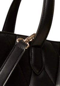 Borsa a tracolla in pelle nera trapuntata con texture liscia, dotata di minuteria color oro e tracolla removibile. Il manico è rinforzato per garantire durabilità.