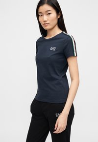 Navyblauw T-shirt met korte mouwen van katoen, met een klein wit logo op de borst en gekleurde strepen langs de schoudernaad.