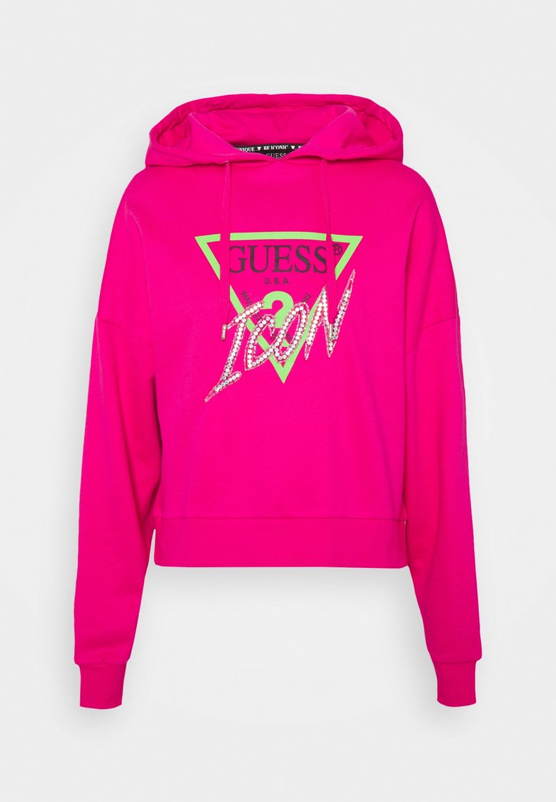 Sudadera cropped rosa con un logo triangular en la parte frontal de color verde y negro, que presenta la palabra "ICON" en lentejuelas. Mangas largas y capucha con cordones.