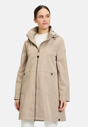 Lichtbeige waterdichte jas met een ritssluiting aan de voorkant, verstelbare capuchon, twee voorzakken en een eenvoudig ontwerp. Soepele textuur, casual pasvorm.