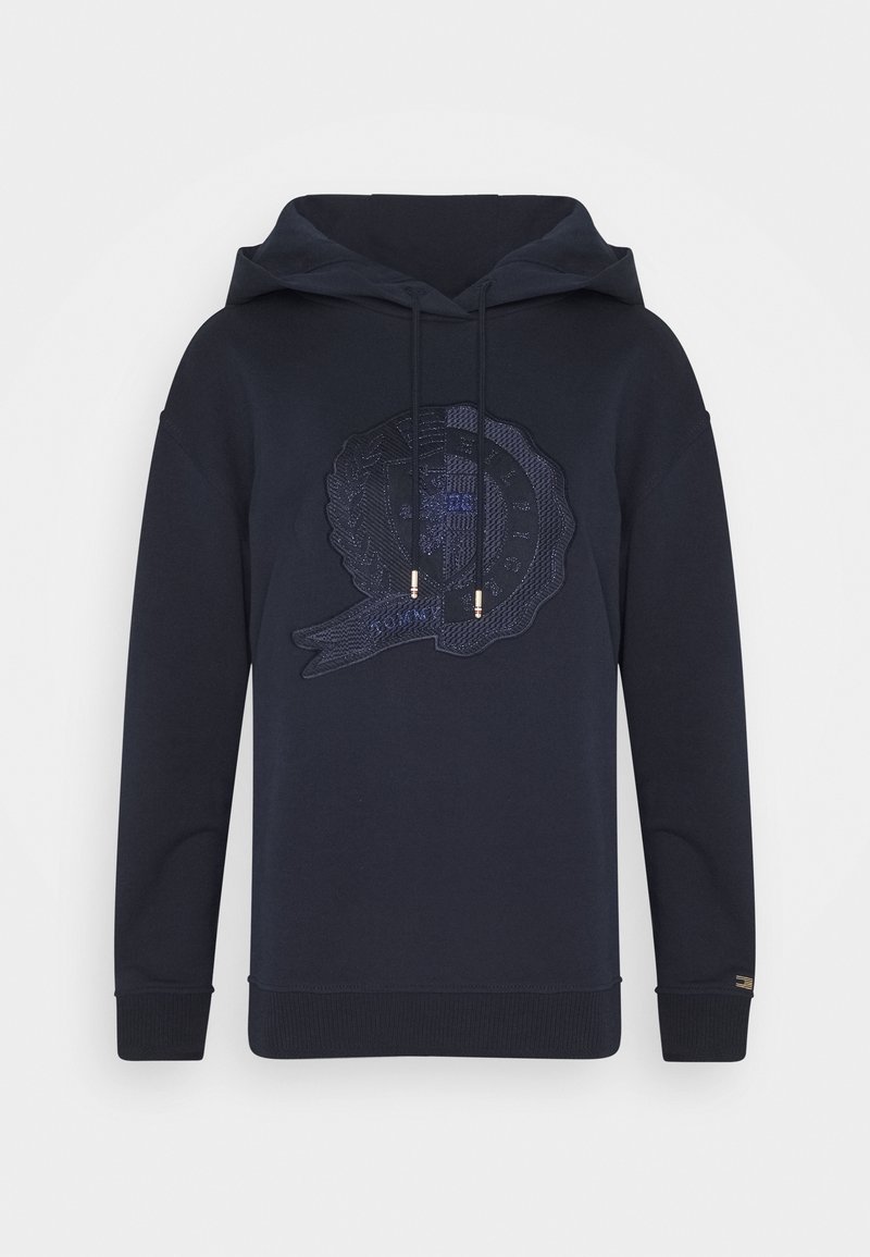 Felpa con cappuccio di colore blu scuro, caratterizzata da un design a emblema testurizzato sul davanti, lacci con dettagli dorati e polsini a coste.
