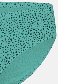 Türkiser Bikini-Unterteil mit schwarzem Punktmuster, aus weichem, dehnbaren Stoff, nahtlosem Design und moderatem Schnitt an Taille und Beinausschnitten.