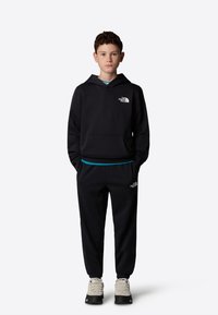 The North Face - REGULAR TAPERED JOGGERS UNISEX - Pantalon de survêtement - tnf black Image miniature 1