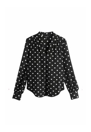 Bluză neagră cu buline albe, decolteu în V, mâneci lungi bufante cu detalii la manșete, textură netedă a materialului, tiv curbat.