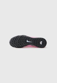 Athletic shoe with a black rubber outsole, pink synthetic upper, and orange accents. Features a white logo on the sole and textured tread pattern.