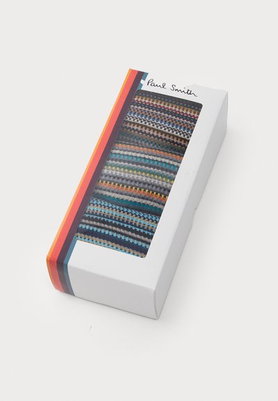 Fargerike sokker i eske med et mønster som har blå, oransje og grå striper, vist gjennom et klart vindu. Esken har Paul Smith-merke.