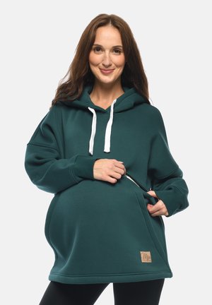 Türkise Kapuzenjacke mit weißen Kordeln, seitlichen Taschen, lockerer Passform und weichem Material. Verfügt über ein Markenetikett am Saum.