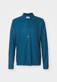 Teal long-sleeve shirt with a button-down collar, ribbed texture, front button closure, and cuffs. Smooth fabric finish, no patterns.