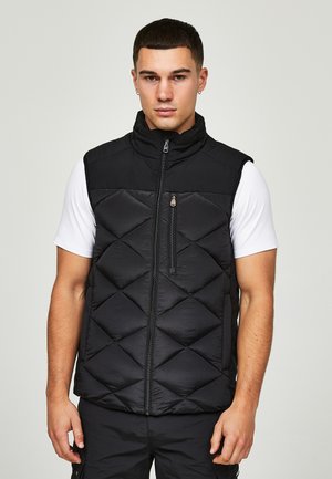 Zwarte gewatteerde vest met een hoge kraag, ritssluiting aan de voorkant en een horizontaal ruitpatroon. Lichtgewicht materiaal met een gladde textuur.