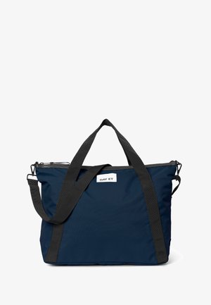 Navy blue tote bag with black straps and a zipper, featuring a white label that reads "DAY ET." Suitable for various uses.