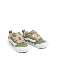 Green suede sneakers with pink laces, white sole, and side stripes. Features a pull tab at the heel and padded collar for comfort.