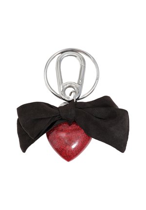 Porte-clés en résine rouge pailletée en forme de cœur, orné d'un nœud en satin noir et d'un clip en métal argenté pour l'attache.
