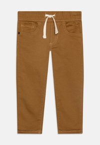 Bruine stretch katoenen broek met een elastische tailleband en trekkoord. Voorzien van zijzakken en een gladde, zachte afwerking.