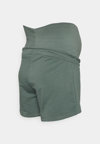 Calções de maternidade em um suave tom verde-oliva, fabricados em mistura de algodão. Apresentam uma cintura flexível e um design ajustado e elegante.