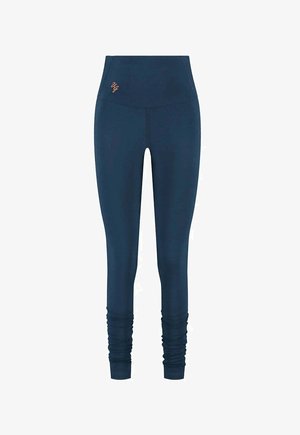 Marineblauwe leggings met een hoge taille, voorzien van een subtiel logo. Glad textuur, plooien bij de enkels en een aansluitend ontwerp.