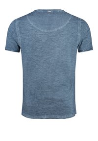 Camiseta de manga corta en un tejido azul claro y texturizado, con cuello redondo y un ajuste relajado. Variaciones tonales distintas a lo largo del material.