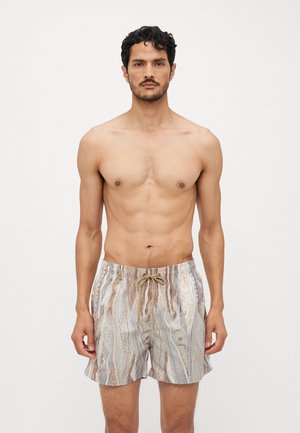 Badetights lavet af et let, struktureret stof med et farverigt, abstrakt slangeskindsdesign, med elastisk talje og snørebånd.