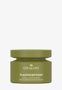 Grønn sylinderformet krukke med matt overflate, med hvit tekst for "Origins" og "Plantscription" på merkelappen, og et tett sittende lokk.