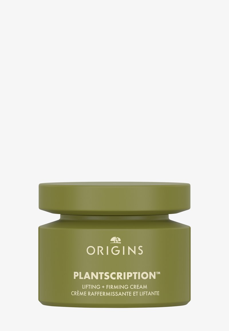 Grønn sylinderformet krukke med matt overflate, med hvit tekst for "Origins" og "Plantscription" på merkelappen, og et tett sittende lokk.