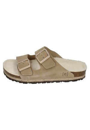 Beige suede slide sandal with two adjustable straps and light-colored buckles. Features a soft, textured insole and a textured rubber sole.