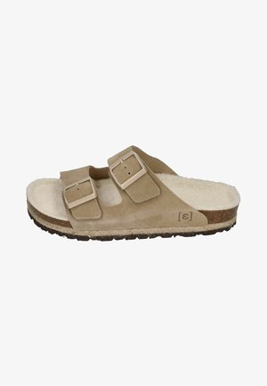 Beige suede slide sandal with two adjustable straps and light-colored buckles. Features a soft, textured insole and a textured rubber sole.
