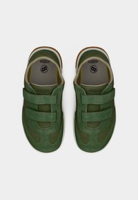 Πράσινα παπούτσια από σουέντ και δίχτυ με δύο λουράκια βέλκρο, στρογγυλεμένη μύτη και λευκή σόλα. Διαθέτουν λογότυπο στο εσωτερικό και υφή στη σόλα.