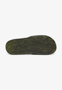 Groene rubberen schoenzool met een reliëftekstpatroon, voorzien van een textuur voor betere grip en afgeronde randen. Gemaakt van duurzame materialen.