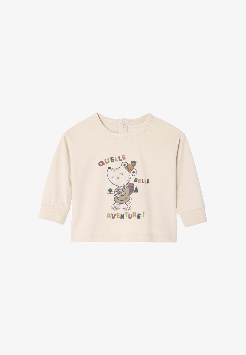 Light beige long-sleeve shirt made of soft fabric featuring a cartoon character with a backpack and text "QUELLE BELLE AVENTURE!"