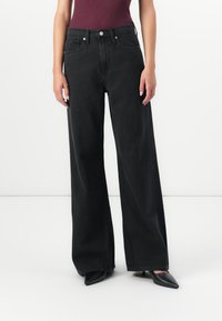 High-waisted wide-leg black jeans made of denim, featuring a classic button and zipper closure with front pockets and a loose fit.