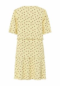 Robe jaune clair à pois marron, manches courtes et jupe à volants.