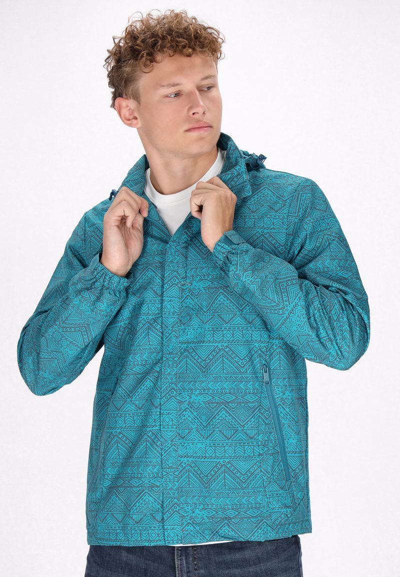Tee-farbene Jacke mit einem Reißverschluss-Design, verstellbarem Kragen und seitlichen Taschen, die geometrische Muster und eine strukturierte Oberfläche aufweist.
