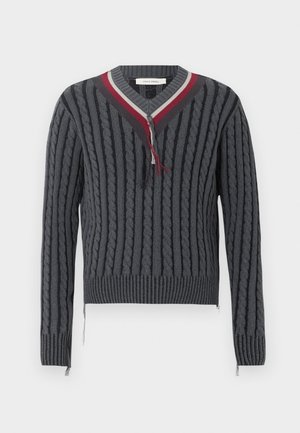 Dark gray cable-knit sweater with ribbed cuffs and hem, V-neck collar with red, white, and dark gray stripes, and frayed details.