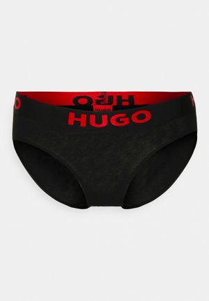 Black underwear with a smooth texture, featuring a wide red elastic waistband with "HUGO" printed in black and red.