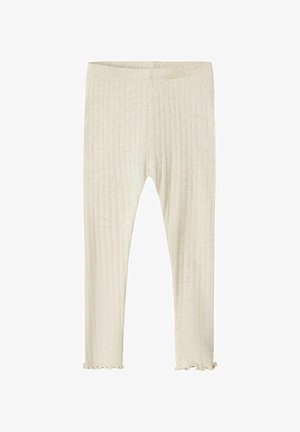 Leggings crèmes à côtes avec un tissu texturé et un ourlet volanté, dotés d'une taille élastique pour le confort et d'une coupe ajustée.