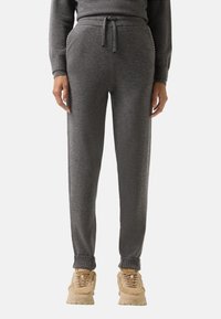 Graue Sweatpants aus weichem Material, mit elastischem Bund und Kordelzug, gerippten Bündchen und zwei Seitentaschen.