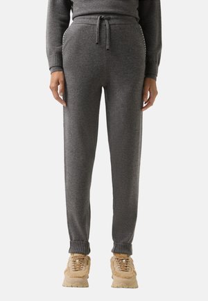 Graue Sweatpants aus weichem Material, mit elastischem Bund und Kordelzug, gerippten Bündchen und zwei Seitentaschen.