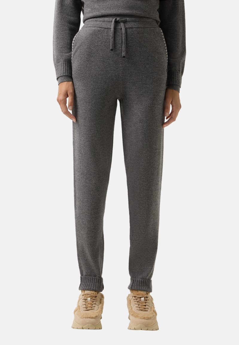 Graue Sweatpants aus weichem Material, mit elastischem Bund und Kordelzug, gerippten Bündchen und zwei Seitentaschen.