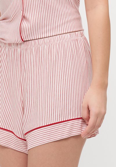 Red and white striped short pajamas with elastic waistband and contrasting trim, made of soft fabric. Features a relaxed fit.