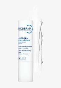 Baume à lèvres Bioderma Atoderm dans un tube cylindrique blanc avec texte bleu. Présente une texture lisse et crémeuse avec un échantillon de crème blanche à côté.